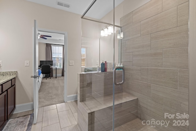 bathroom featuring ceiling fan, wood-type flooring, vanity, and an enclosed shower