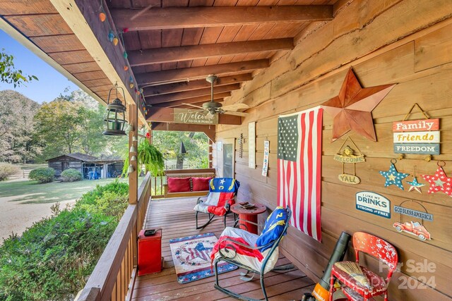 wooden terrace featuring ceiling fan