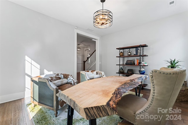 dining area with an inviting chandelier and hardwood / wood-style flooring