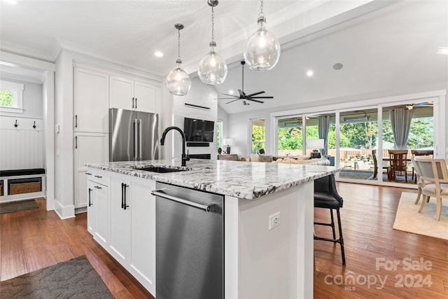 kitchen featuring white cabinets, a kitchen island with sink, stainless steel appliances, and plenty of natural light