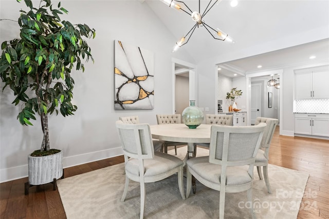 dining room with vaulted ceiling and hardwood / wood-style flooring