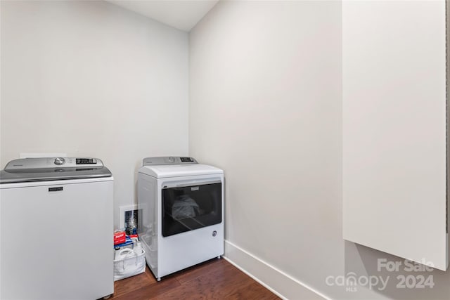 laundry area with dark wood-type flooring and washing machine and dryer