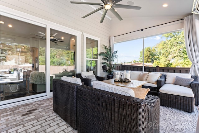 sunroom with lofted ceiling, ceiling fan, and a wealth of natural light