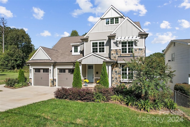 view of front of house featuring a front yard and a garage