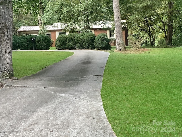 305 N Milford Dr, Salisbury, NC 28144 - view of front of house featuring a front lawn, driveway, and brick siding