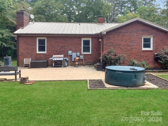305 N Milford Dr, Salisbury, NC 28144 - rear view of house featuring a chimney, brick siding, a patio area, and a lawn