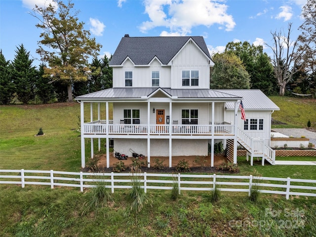 modern farmhouse style home with covered porch and a front lawn