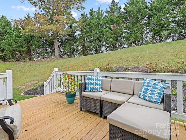 wooden deck with an outdoor hangout area and a yard