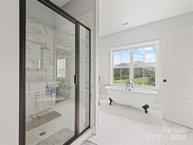 bathroom featuring shower with separate bathtub