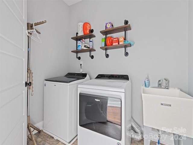 washroom with sink and separate washer and dryer