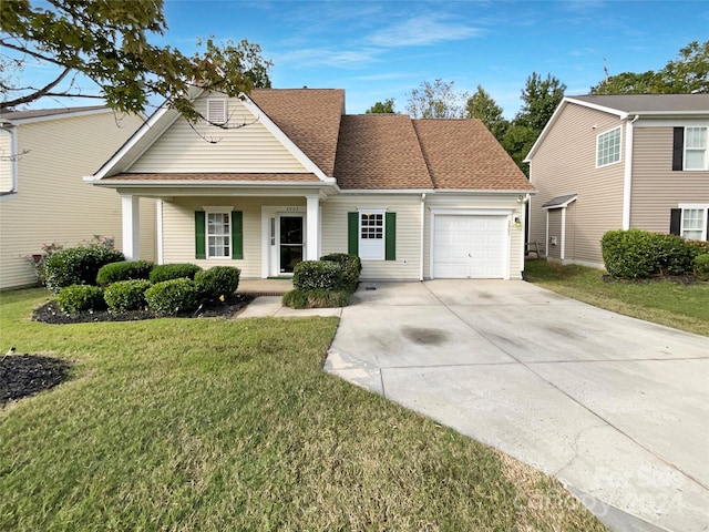 view of front of house featuring a front yard and a garage