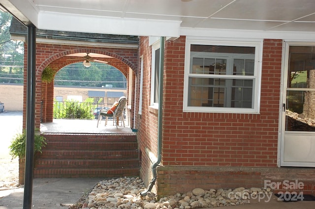 exterior space with ceiling fan and a porch