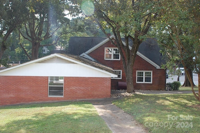 view of side of home featuring a yard