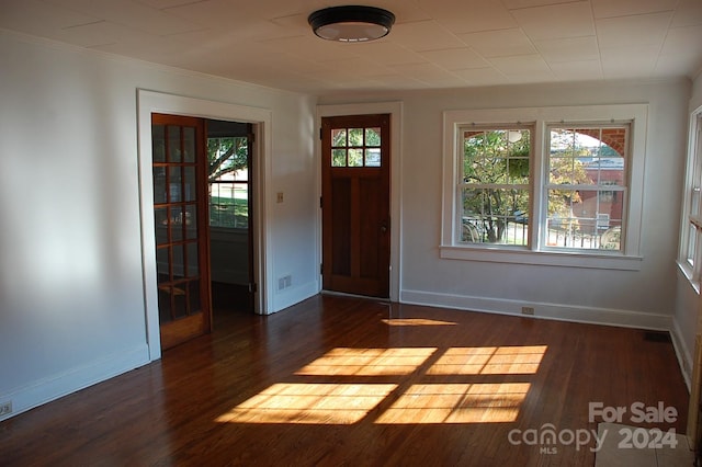 foyer featuring ornamental molding and dark hardwood / wood-style flooring