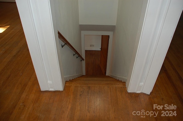 stairs with wood-type flooring