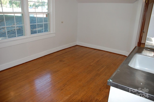 spare room featuring hardwood / wood-style flooring and sink