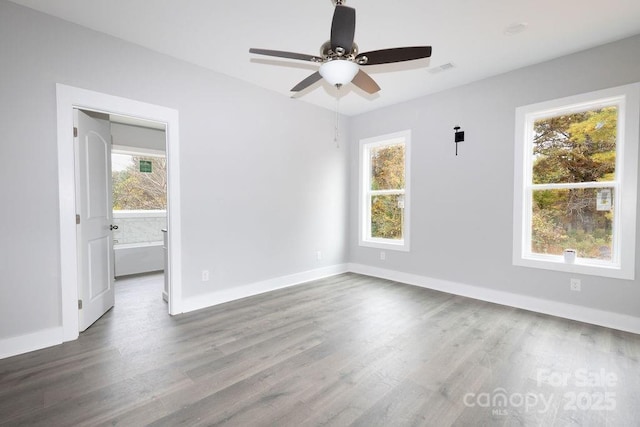 unfurnished room with hardwood / wood-style flooring and a healthy amount of sunlight