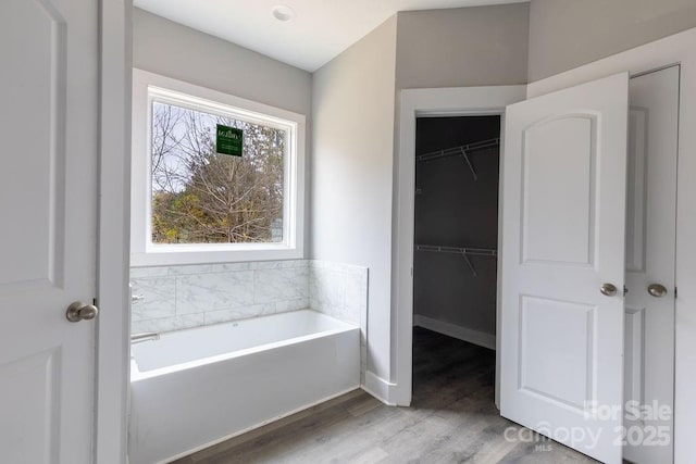 bathroom featuring hardwood / wood-style floors and a tub