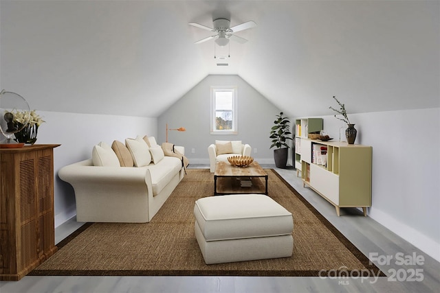 living room featuring ceiling fan and vaulted ceiling