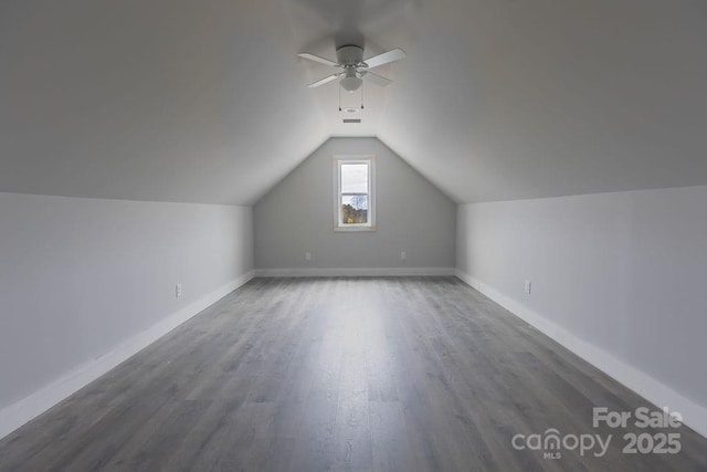 additional living space featuring ceiling fan, dark hardwood / wood-style floors, and vaulted ceiling