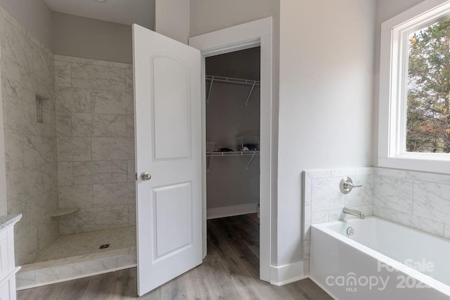 bathroom with vanity, hardwood / wood-style floors, and separate shower and tub