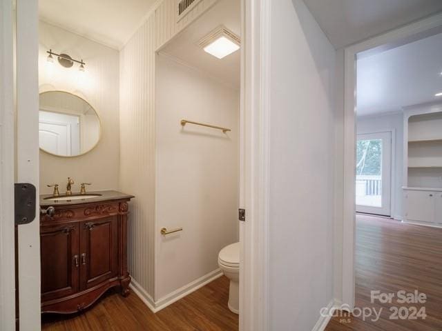 bathroom featuring vanity, toilet, and hardwood / wood-style floors