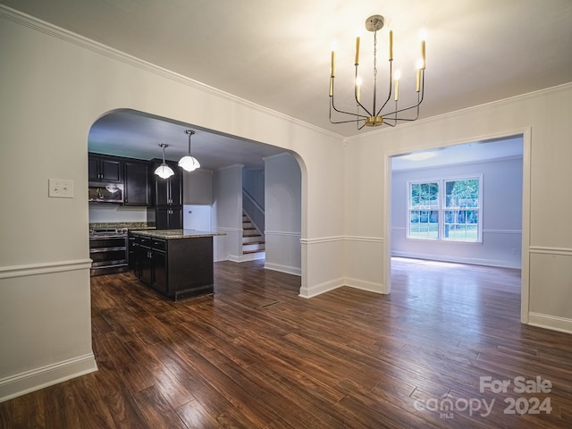 kitchen featuring appliances with stainless steel finishes, a center island, dark hardwood / wood-style flooring, pendant lighting, and ornamental molding