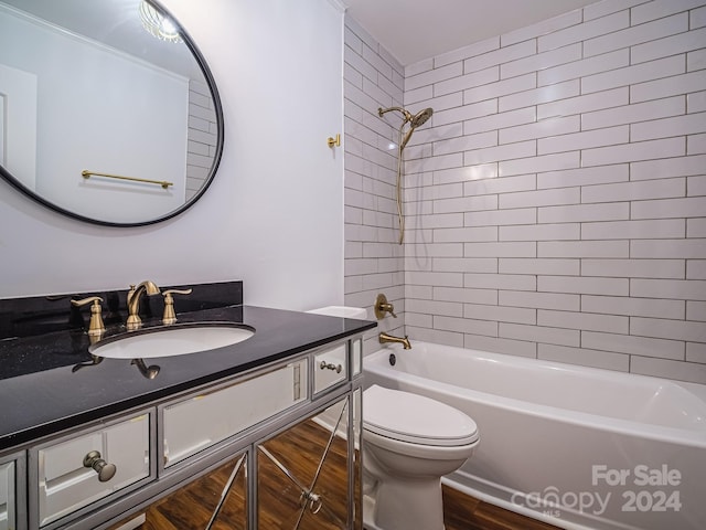 full bathroom featuring toilet, tiled shower / bath, vanity, and wood-type flooring