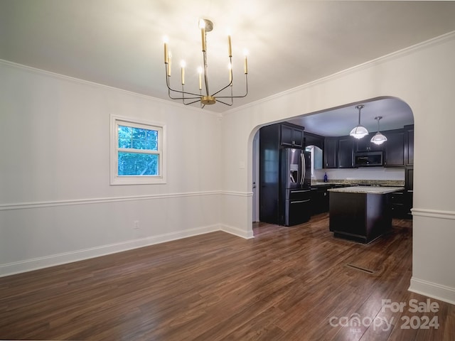 kitchen featuring dark hardwood / wood-style floors, stainless steel appliances, crown molding, decorative light fixtures, and a center island