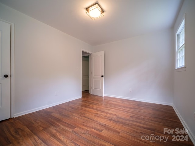 spare room with dark hardwood / wood-style flooring