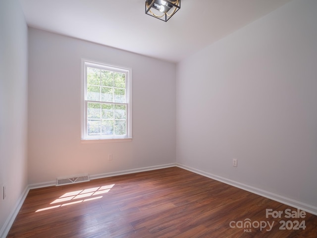 empty room with dark hardwood / wood-style floors