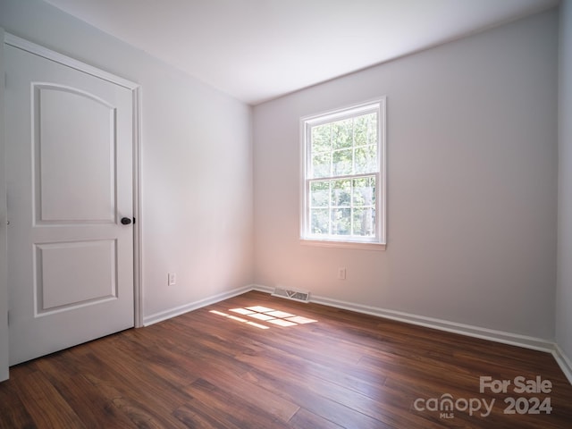 empty room featuring dark hardwood / wood-style flooring