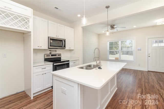 kitchen featuring white cabinetry, stainless steel appliances, sink, and an island with sink