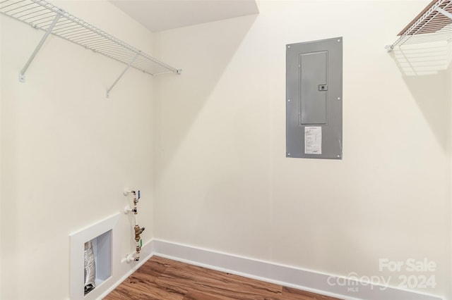 laundry room with hardwood / wood-style flooring and electric panel