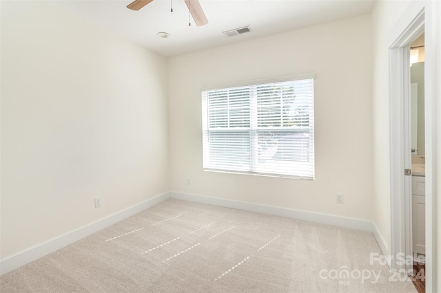 unfurnished room with light carpet and ceiling fan