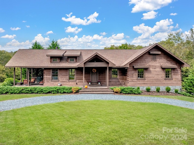 view of front of home featuring covered porch and a front yard