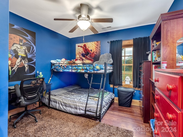 bedroom with ceiling fan and dark hardwood / wood-style floors