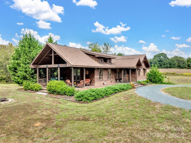 rear view of property with a yard