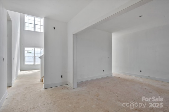 unfurnished room featuring baseboards