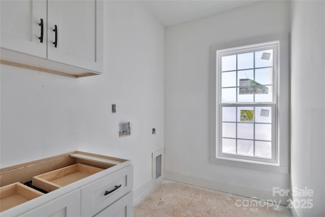 washroom with washer hookup, cabinet space, electric dryer hookup, and baseboards