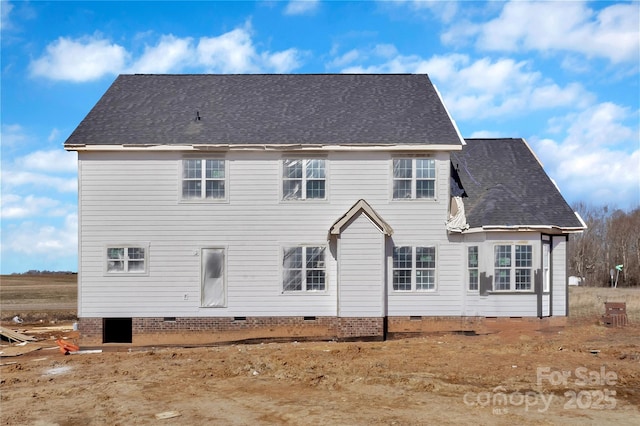 rear view of house featuring crawl space and a shingled roof