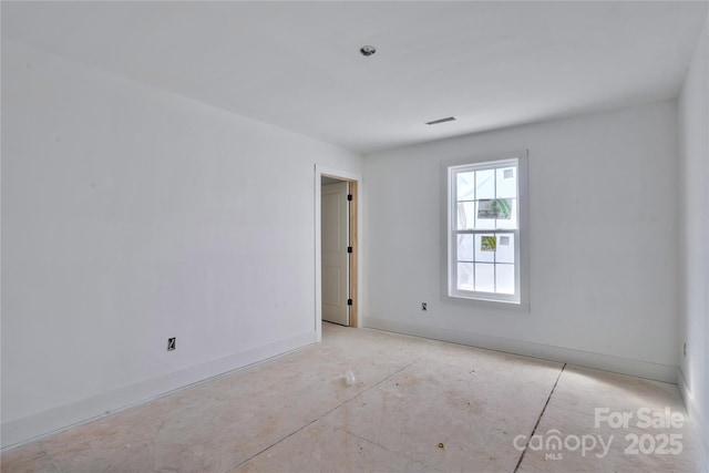 spare room featuring visible vents and baseboards