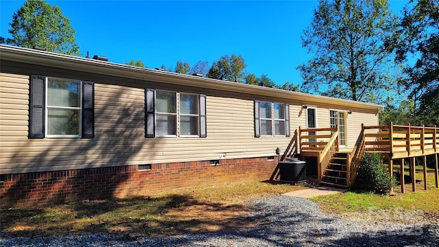 exterior space featuring a wooden deck and cooling unit