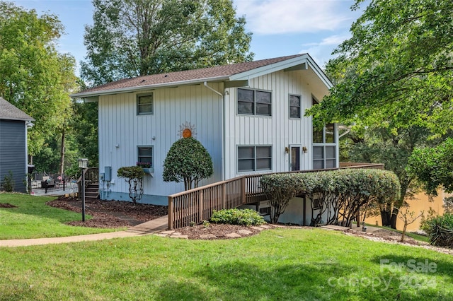 rear view of property with a yard