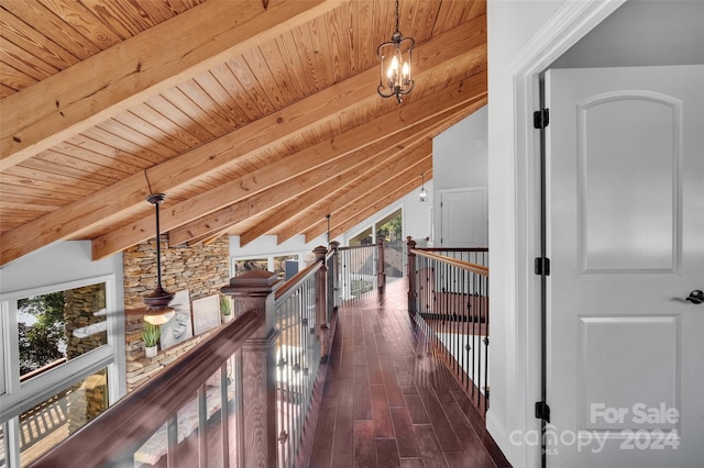 hall featuring vaulted ceiling with beams, dark hardwood / wood-style flooring, a wealth of natural light, and wooden ceiling