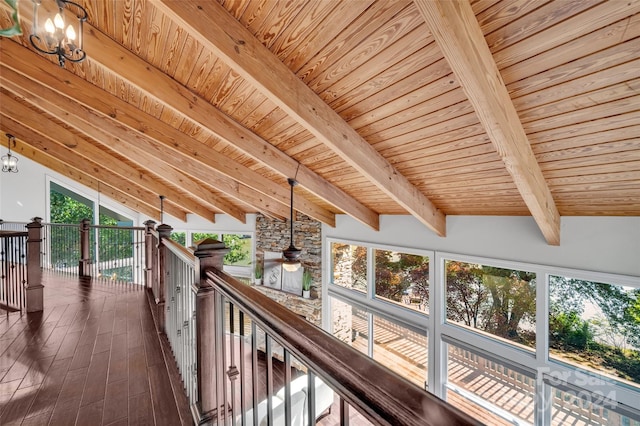 corridor featuring vaulted ceiling with beams, wood ceiling, and an inviting chandelier