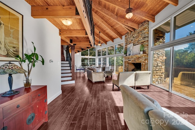 sunroom / solarium featuring a fireplace and vaulted ceiling with beams