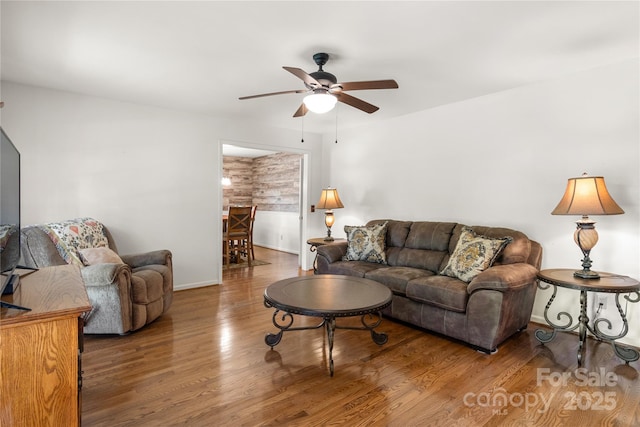 living room with hardwood / wood-style floors and ceiling fan