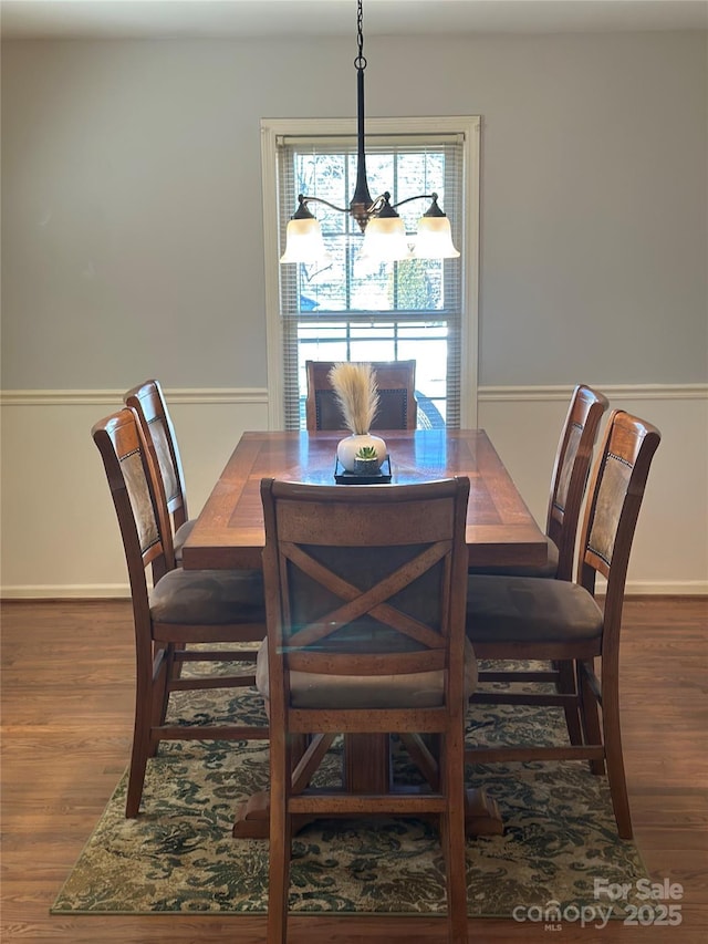 dining space featuring a notable chandelier and wood-type flooring