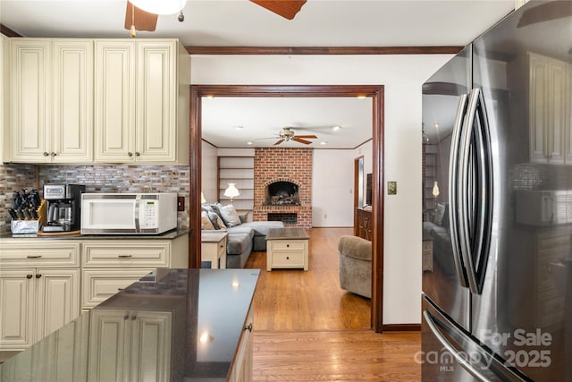 kitchen featuring ceiling fan, refrigerator, cream cabinets, and light wood-type flooring